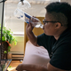 Katherine Morgan drinks water in front of a box fan while trying to stay cool in her downtown apartment without air conditioning on Thursday, Aug. 12, 2021, in Portland, Oregon.